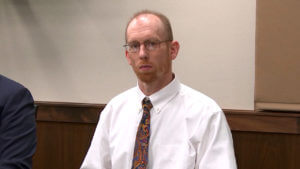 Chad Isaak sits in court