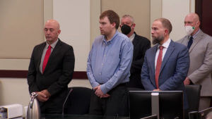 Travis Reinking stands in court