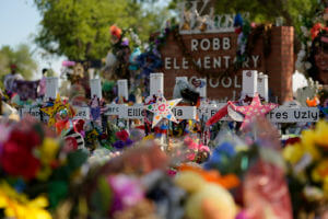 Crosses, flowers and other memorabilia form a make-shift memorial for the victims of the shootings at Robb Elementary School in Uvalde
