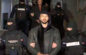 Andrew Tate is led away by police