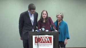 Woman speaks at press conference