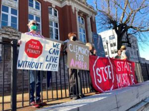 protesters hold signs outside the Missouri Supreme Court building while protesting the execution of Amber McLaughlin on Tuesday, Jan. 3