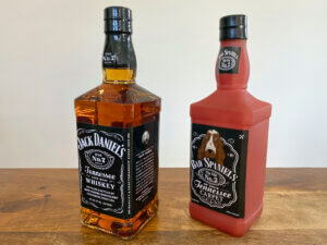 Bottle of Jack Daniel's next to a Bad Spaniels dog toy.