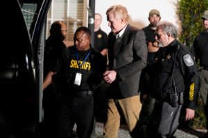 Alex Murdaugh is led outside the Colleton County Courthouse by sheriffs deputies.
