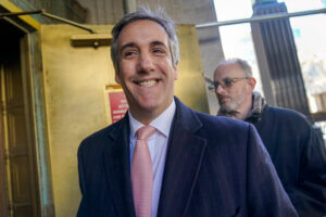 Donald Trump’s former lawyer and fixer Michael Cohen smiles as he arrives for a second day of testimony before a grand jury 
