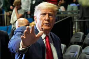 Former President Donald J. Trump waves as he arrives for the NCAA Wrestling Championships