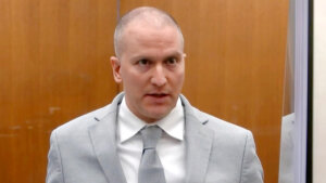 Derek Chauvin, dressed in a suit, addresses the court.