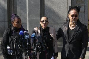 Kathryn Townsend Griffin, center, daughter of singer and songwriter Ed Townsend, speaks outside New York Federal Court