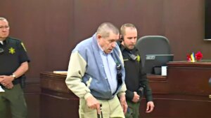 Andrew Lester walks in court