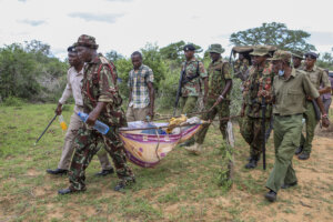 Police and local residents load the exhumed bodies