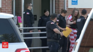 Lori Vallow Daybell is seen smiling while walking to the car with police