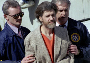 Ted Kaczynski is flanked by federal agents