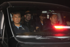 Joran van der Sloot is driven away from prison in a police vehicle.