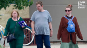Asa Ellerup and Victoria Heuermann walk through a Best Buy parking lot