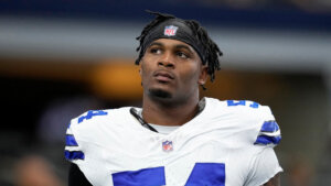 Sam Williams, wearing a Dallas Cowboys football uniform, looks up off camera