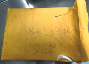 Yellow envelope with handwriting on it and a small tear