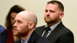 Former Aurora, Colo., Police Officer Jason Rosenblatt, left, and Aurora Police Officer Randy Roedema, right, attend an arraignment at the Adams County Justice Center.