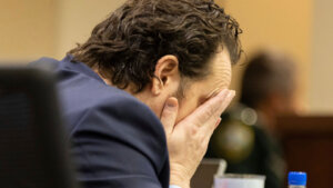 Charlie Adelson puts his head in his hands