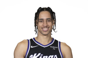 A basketball player smiles at the camera
