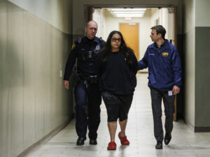 Christopher Preciado, center, is escorted by San Antonio Police