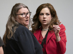 Jennifer Crumbley stands with her attorney.