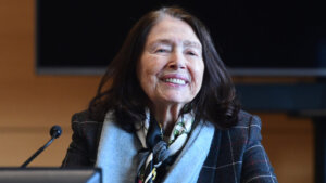 A woman smiles on the witness stand