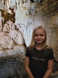 Audrii Cunningham stands in front of a rock face