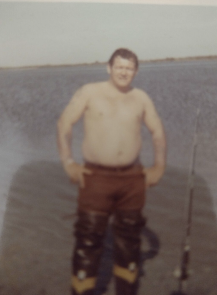 photo of shirtless man on beach