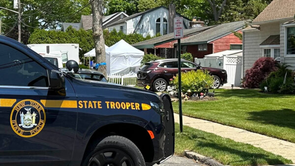 law enforcement fill the front yard of Rex Heuermann's home