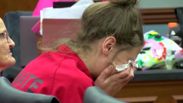 Tesla Tucker cries with her head in her hands during a court hearing
