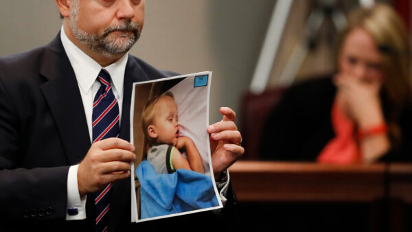 attorney holds picture of sleeping child