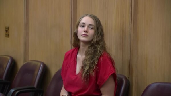 woman sits in jumpsuit