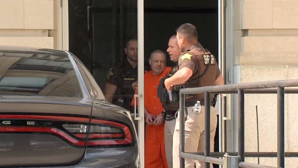 Richard Allen is escorted out of a courthouse