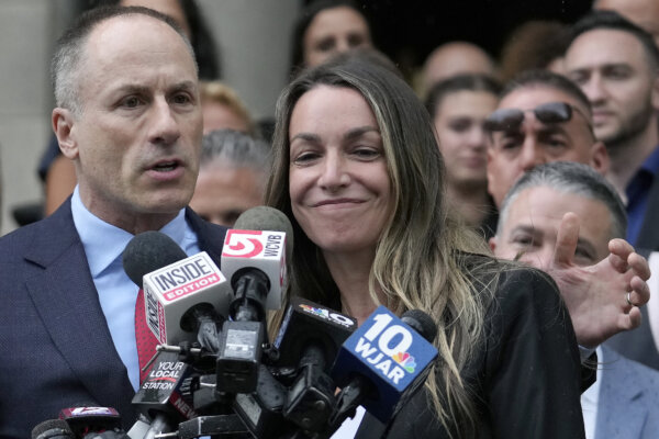 Karen Read smiles with her attorneys outside of court.