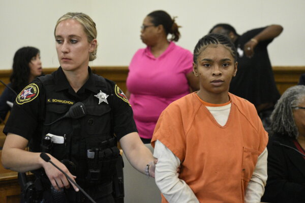 woman escorted by female deputy