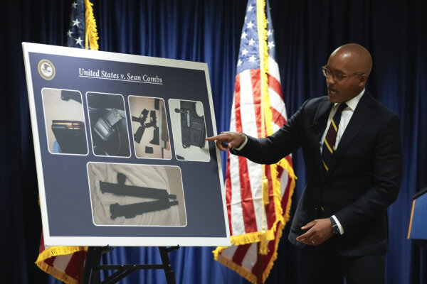 a man points to photos on a poster