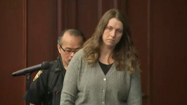 Shanna Gardner walks into court wearing a gray sweater