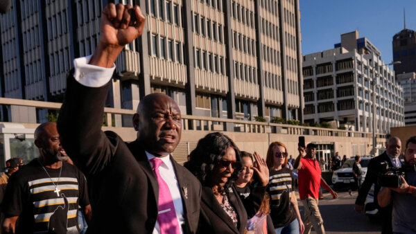 Attorney Ben Crump, left, and RowVaughn Wells, second from left, mother of Tyre Nichols
