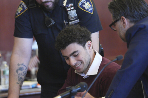 Luigi Mangione smiles in court