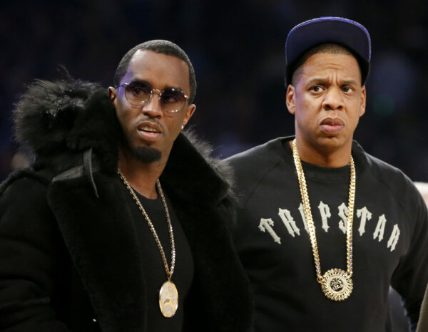 Sean "Diddy" Combs, left, and Jay-Z attend the NBA All-Star basketball game