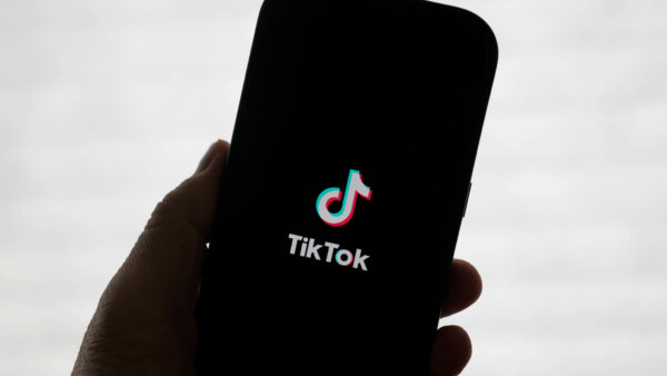 A TikTok logo is shown on a phone