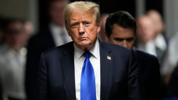 Donald Trump walks to make comments to members of the media
