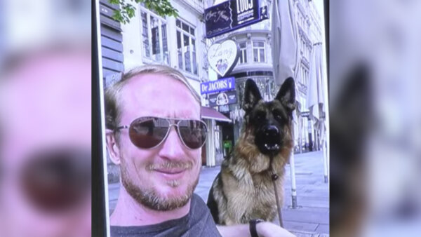 zachary young poses with his dog