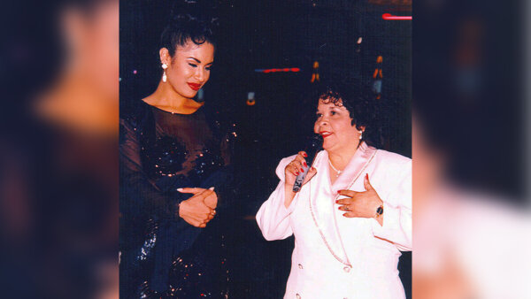 Selena, left, watches as Yolanda Saldivar speaks to a crowd