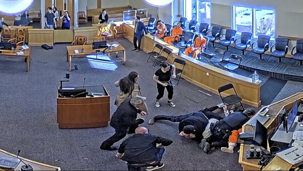 still from video shows brawl in courtroom