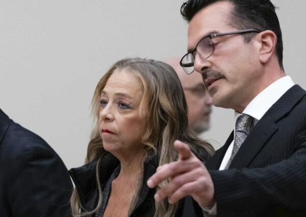 Kim Sullivan who is charged with neglect, stands with her attorney