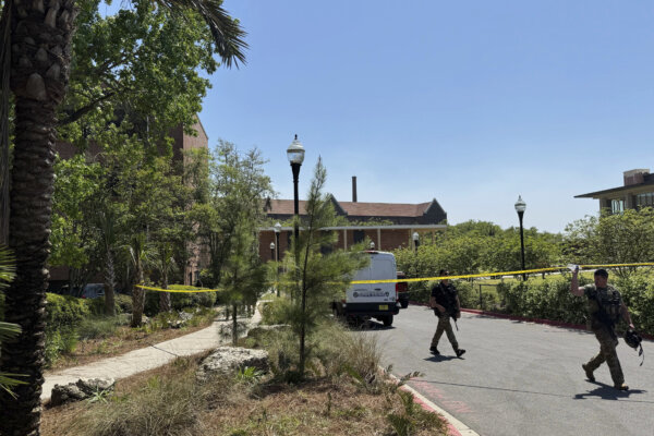 patrol vehicles, including a forensics van, are stationed outside of Florida State University’s student union building