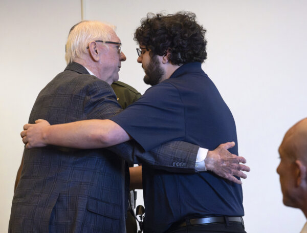 Jeffrey Ferguson, left, embraces his son, Phillip Ferguson