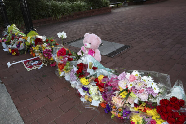 memorial of flowers and other items laid near the center of the Florida State campus