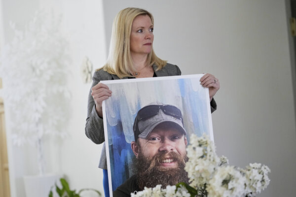 Stacey Wales, sister of the late Christopher Pelkey, displays her brother's image